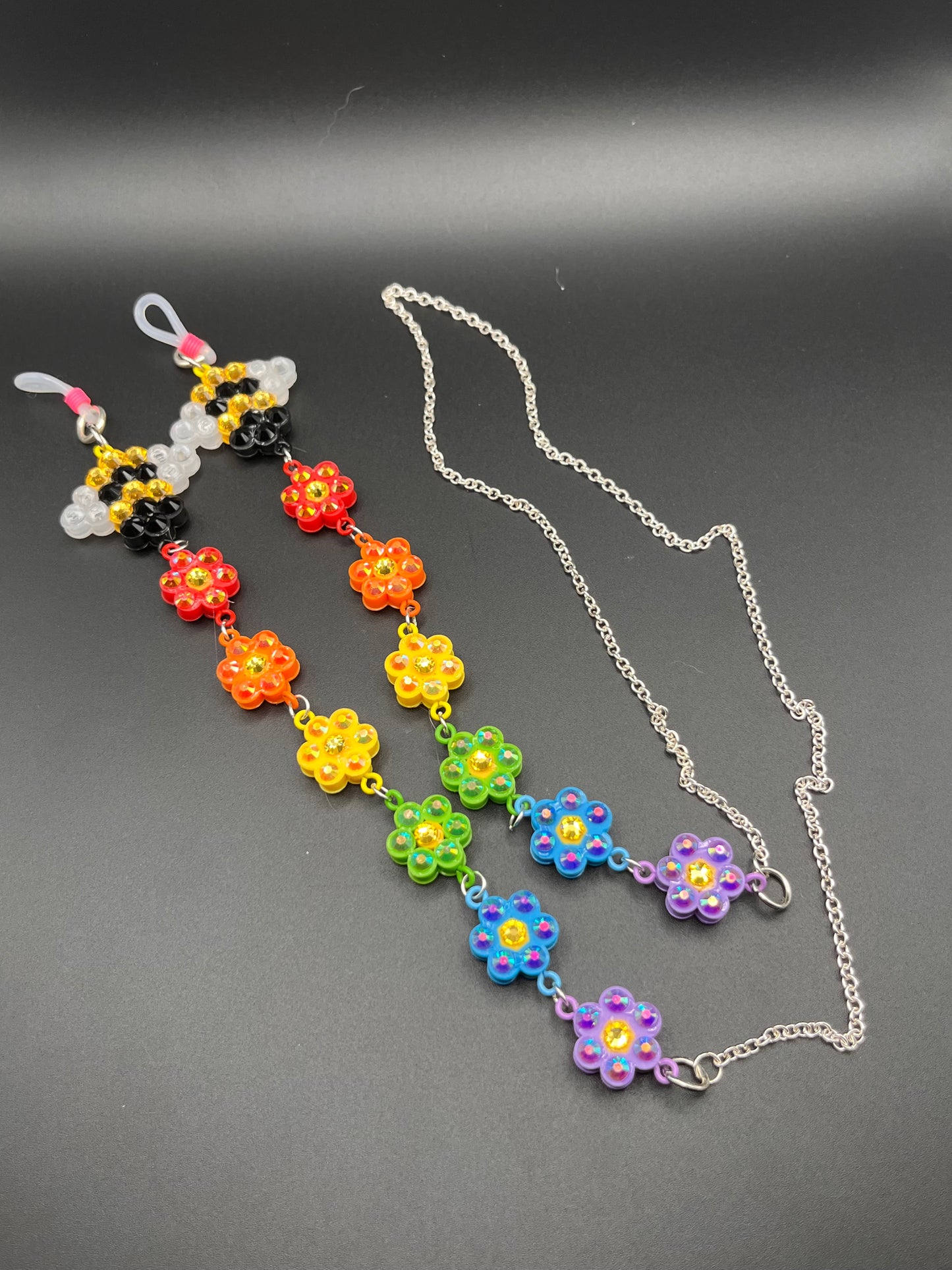 Rainbow and bee charm rhinestoned 33” eyeglass chain made with fused beads and glass rhinestones.